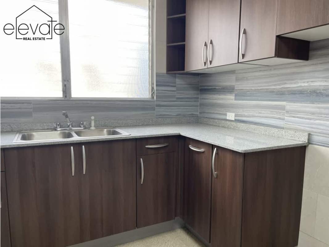 Renovated kitchen with granite countertops, large window and modern cabinetry PH Entremares El Cangrejo Panama City