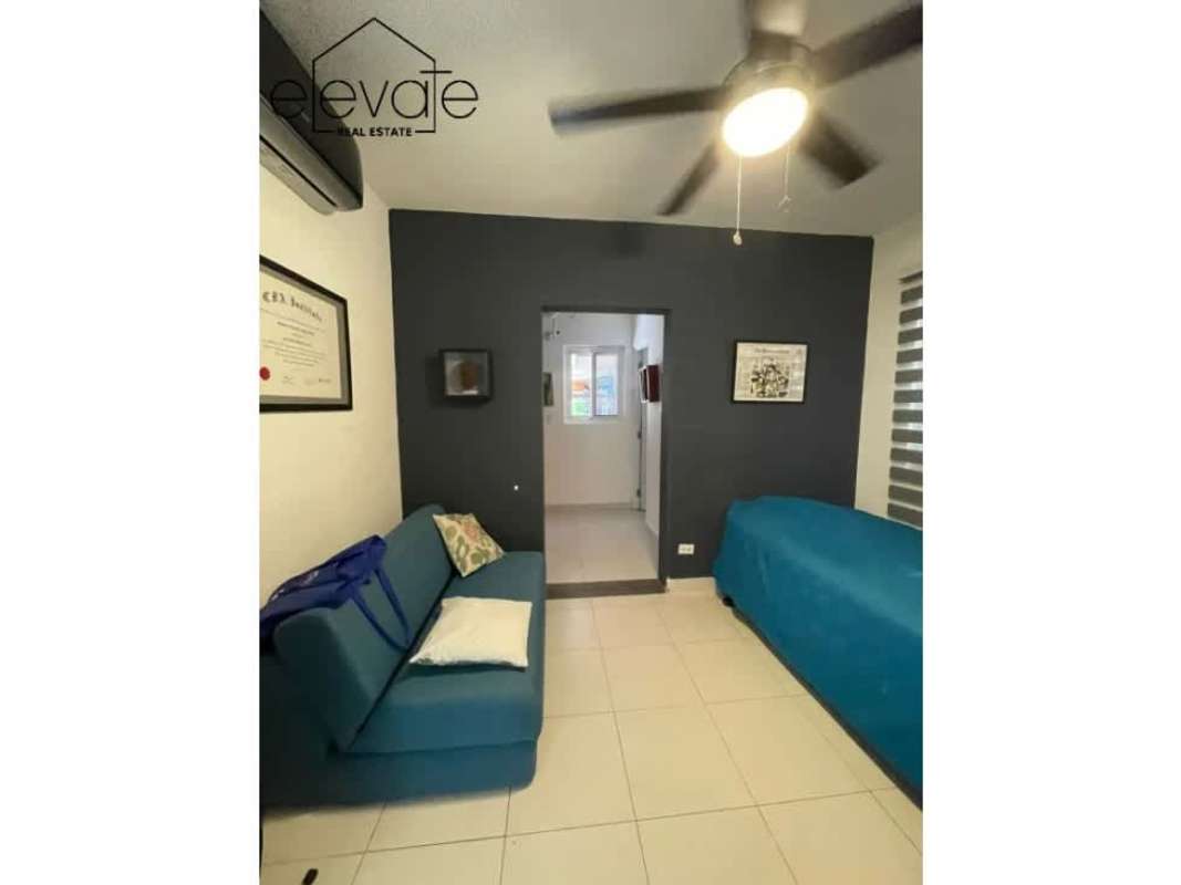 Modern dining space with natural light, pendant light and artwork in Costa Sur Panama house with pool