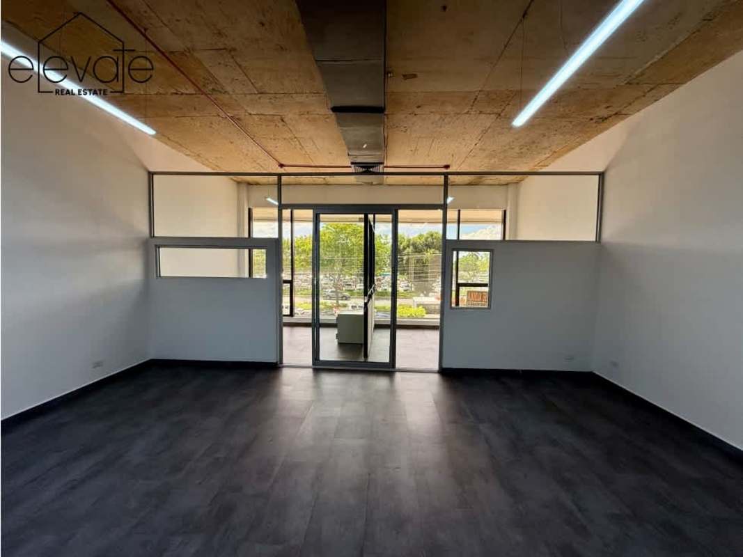 Open space office with exposed concrete ceiling and large windows Galería Balboa Panama