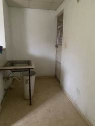 Small peach-colored house with fenced yard and concrete wall at Altos del Tecal Panama Oeste