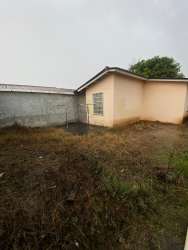 Exterior view of fenced yard and window with bars in Vacamonte house