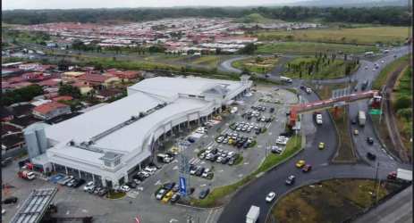Retail strip mall entrance with signage and parking Colon Panama