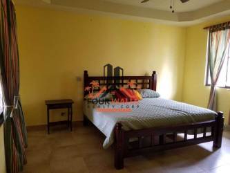 Private swimming pool with jacuzzi and thatched bohío gazebo in Coronado Golf Club villa Panama