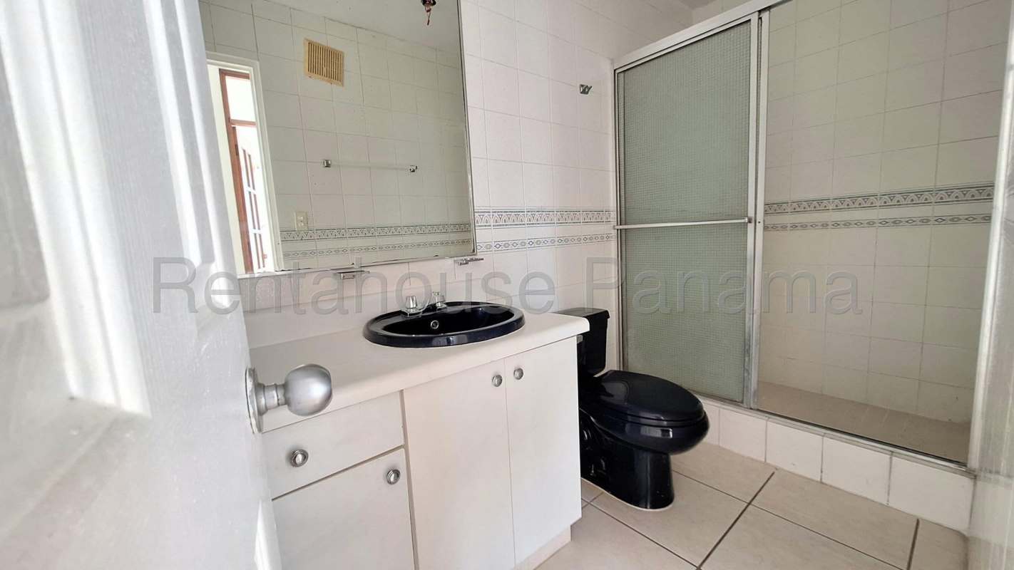 Minimalist kitchen with white tile and cabinets PH Coco Mar Panama