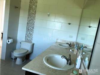 Modern kitchen with granite countertops and stainless steel appliances in Bijao Beach Condo Panama