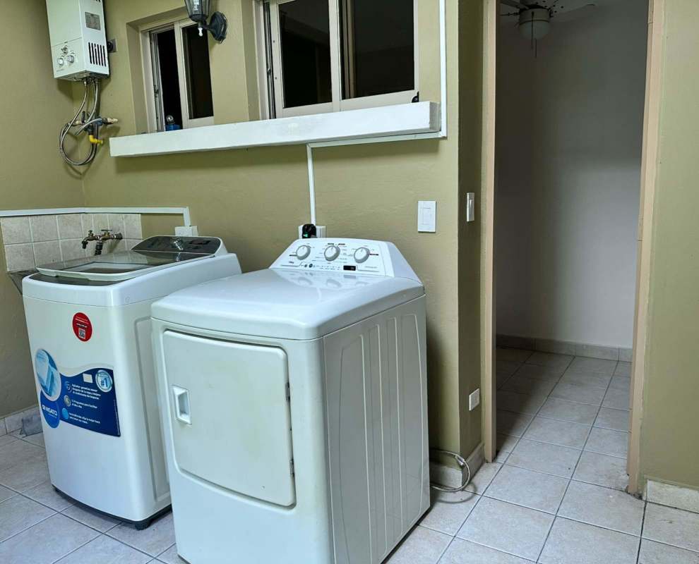 Outdoor covered terrace with tiled floor, ceiling fan, garden view in Clayton Private Residential