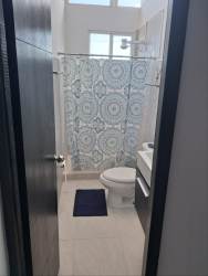 Master bedroom with high windows, natural light at Coronado beach house rental Panama