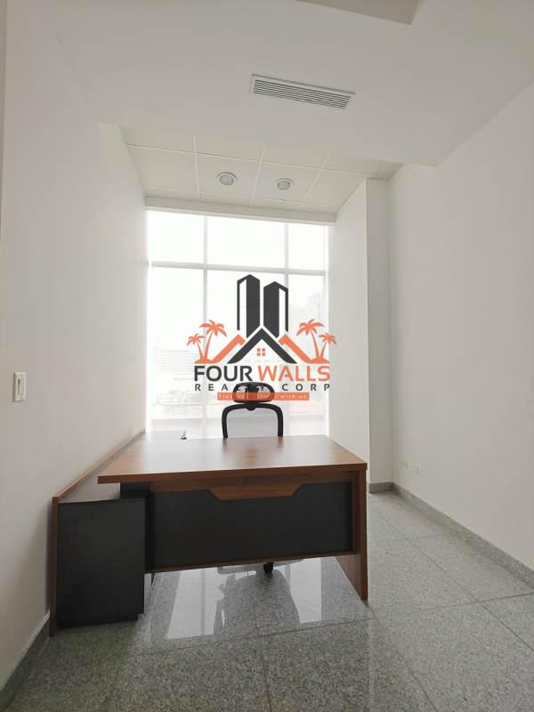 Minimalist private office room with executive desk and large window PH Bicsa Financial Center Panama City