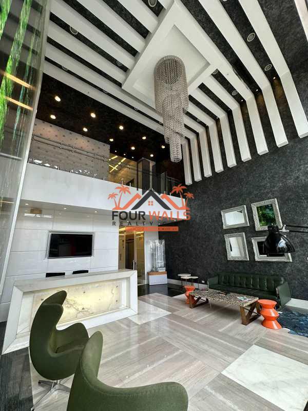 Modern luxury office building lobby with chandelier and green furniture at PH Bicsa Financial Center Panama City