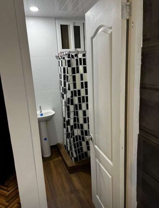 Compact bathroom with pedestal sink, shower, modern tiles Diablo Heights apartment