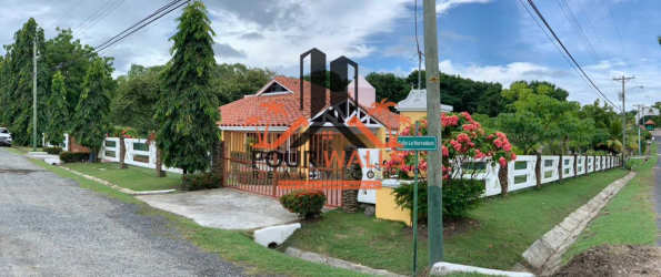 Secure entry gate with lush landscaping Club Ecuestre Coronado Panama property sale