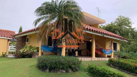 Front garden Mediterranean home style in Club Ecuestre Coronado Panama for sale by Hola Realty