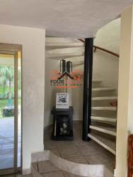 Spiral staircase and tiled foyer in equestrian community house Coronado Panama
