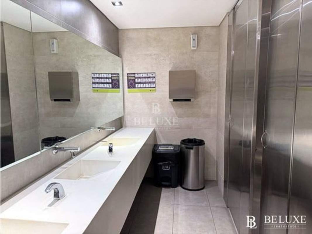 Modern restroom facilities with dual sinks, mirrors, stainless stalls in Santa Maria Business District Panama