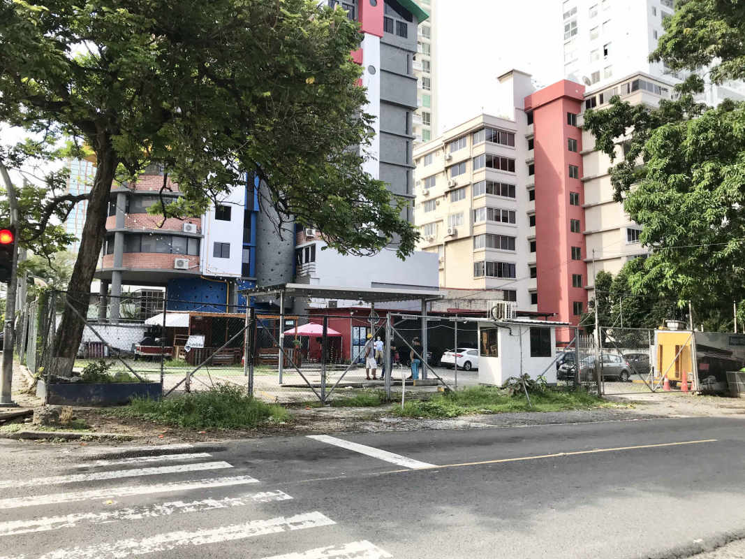 Vacant lot with chain-link fence street utilities and apartment buildings nearby Coco del Mar Panama
