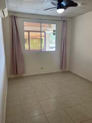 Bedroom with wall split AC, closet space, window, beige walls Arboledas La Chorrera Panama