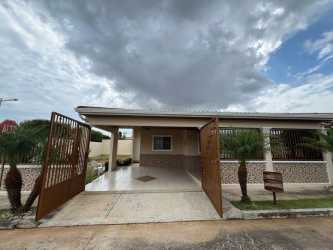 Driveway with gate and covered carport at corner house in Arboledas Cluster Los Castaños Panama