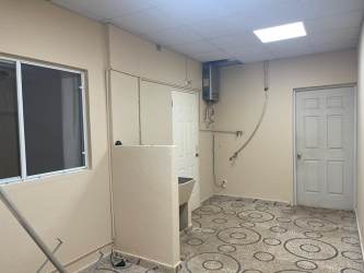 Basic laundry utility room with sink, window, tiled floor in corner house Arboledas Panama