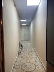 Long corridor hallway with tiled floors and beige walls La Chorrera house