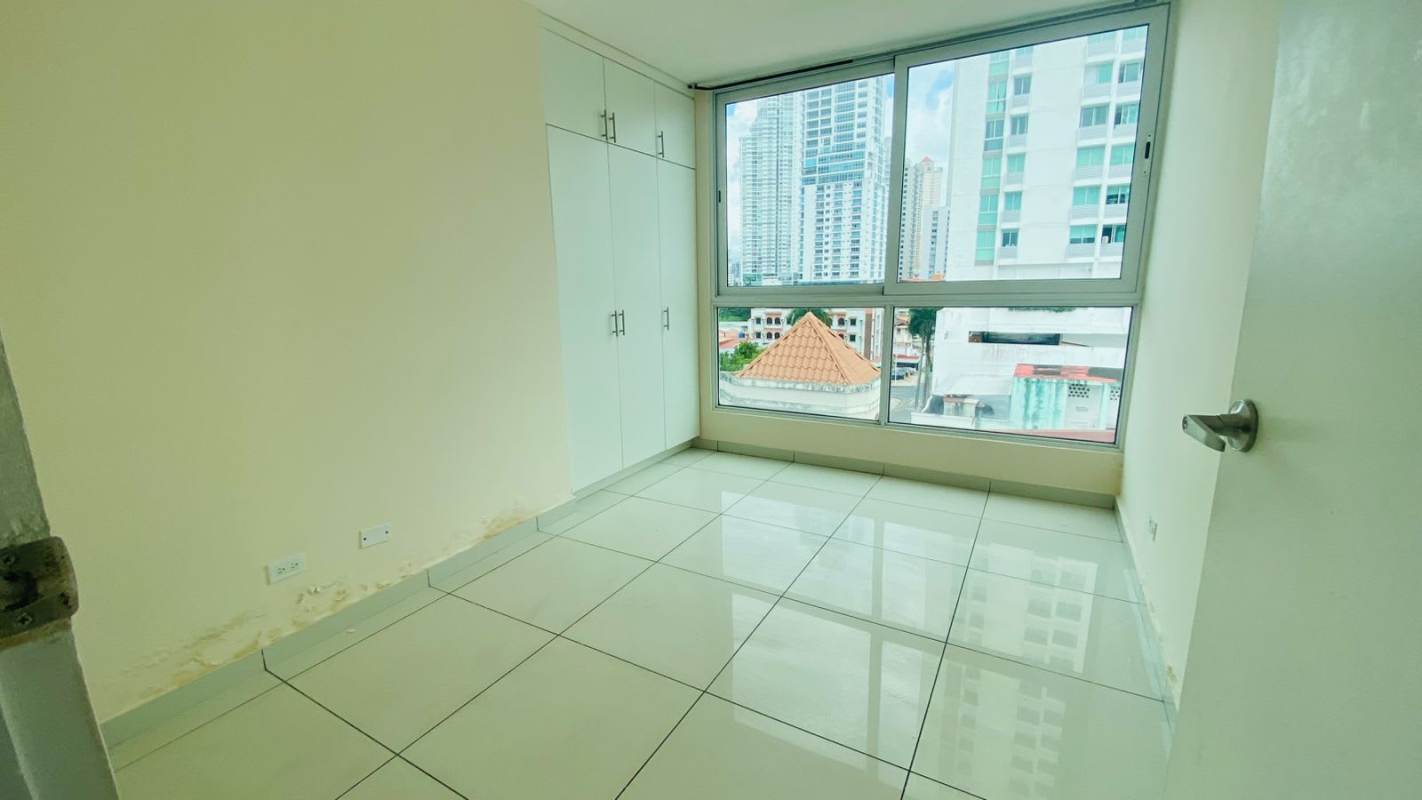 Bright master bedroom with ceramic floor, built-in closet, large window city view in Bella Vista Panama