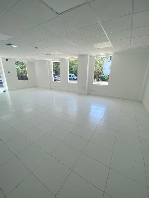 Modern two-story commercial office building with wood accents, balconies and parking Quarry Heights Panama