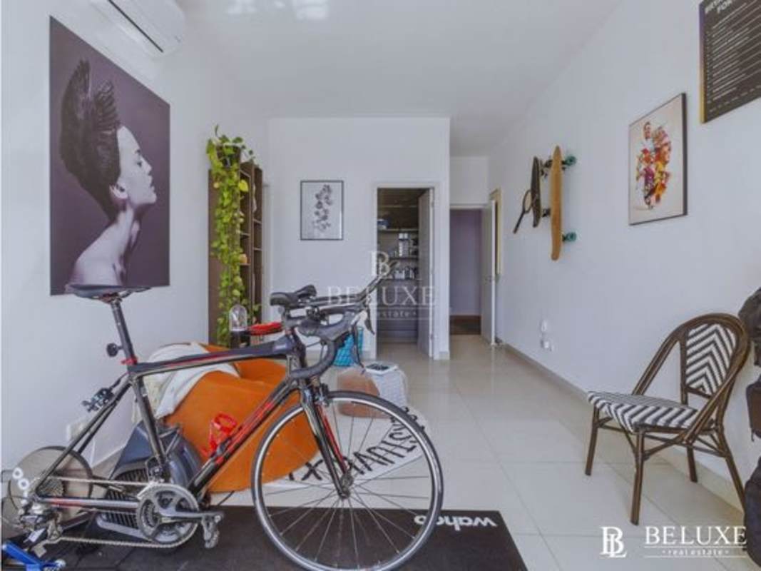 Modern living room with large windows, access to enclosed terrace at PH Astoria El Cangrejo Panama