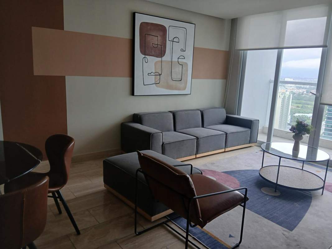 Modern living room with sectional sofa, panoramic city views at The Regent Costa del Este Panama
