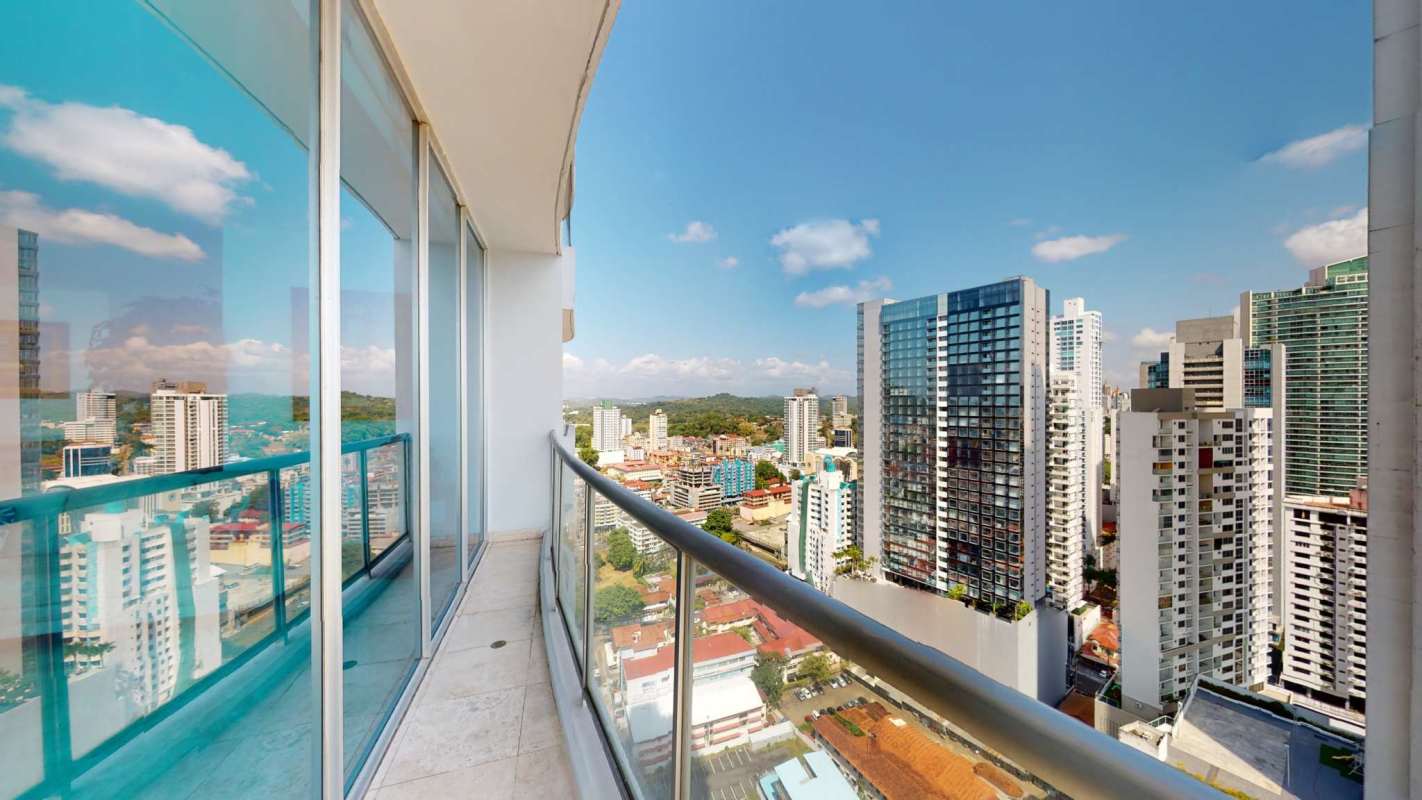 Modern bathroom with glass shower and marble counters in PH Sky Panama Apartment