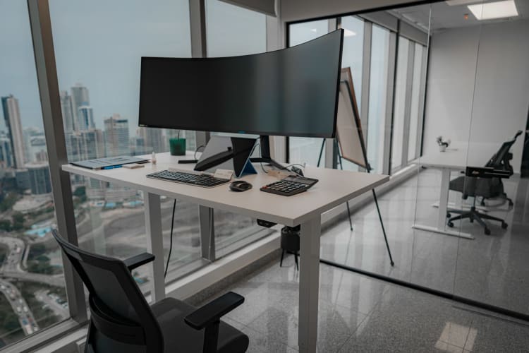 Floor-to-ceiling windows showing full city skyline from RBS Tower office floor Panama City