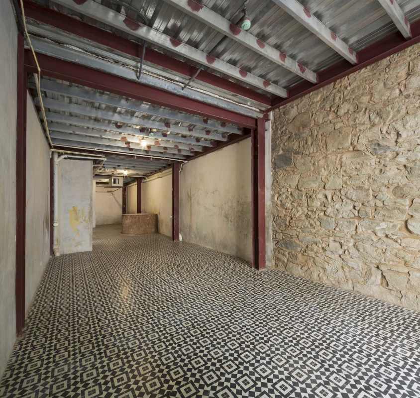 Unfinished basement with exposed beams, partial stone wall, Casco Viejo Panama
