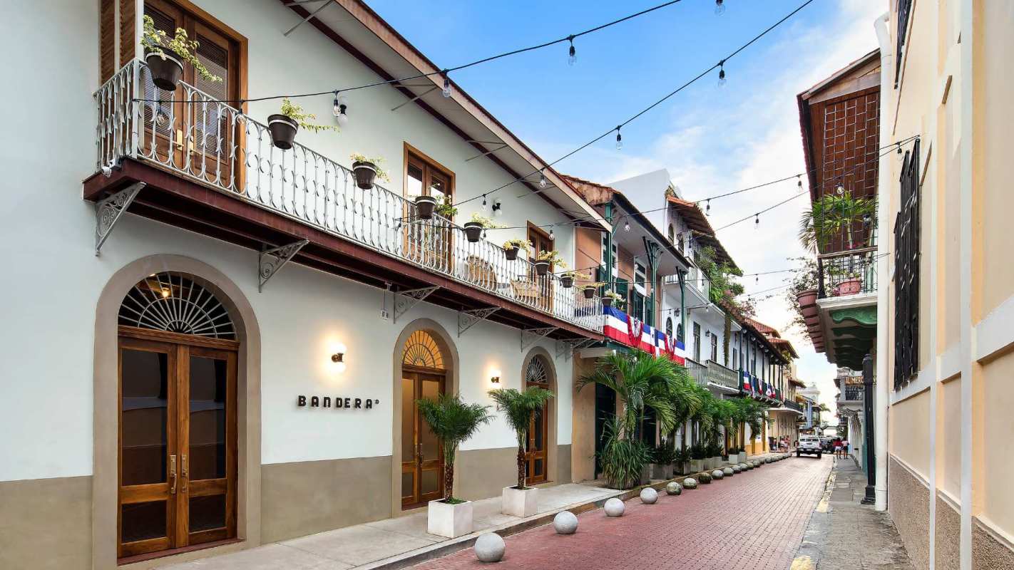 Colonial style street with historic buildings balconies flags and cobblestone streets Casco Viejo Panama