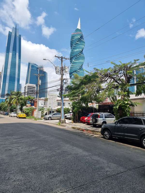Modern twisting skyscraper and urban commercial properties behind redevelopment lot in Obarrio Panama
