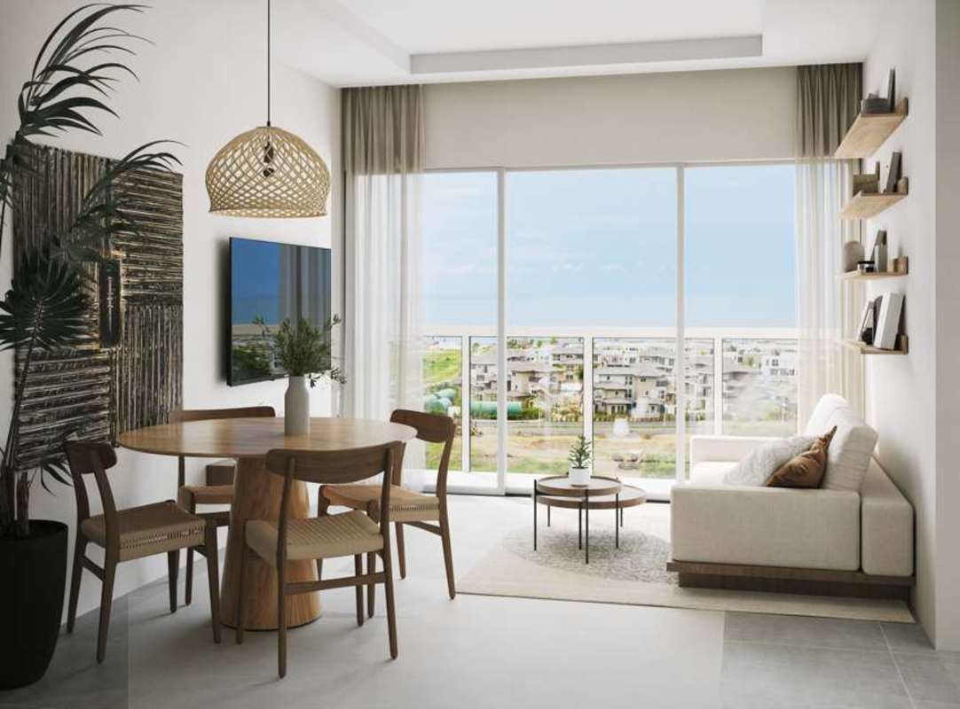 Bright living area with large windows, modern decor, balcony access overlooking beachfront resort in Punta Chame Panama