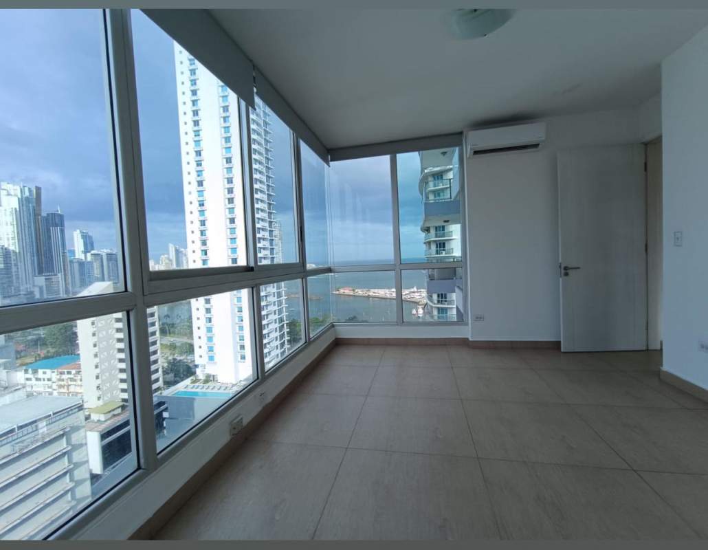 Living and dining area with large windows and Pacific Ocean view at PH BICSA Panama City