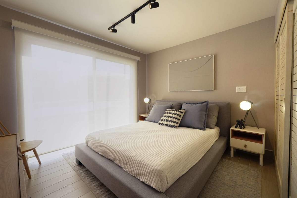 Aerial photo showing pool, mountain backdrop, condos, parking at Playa Caracol