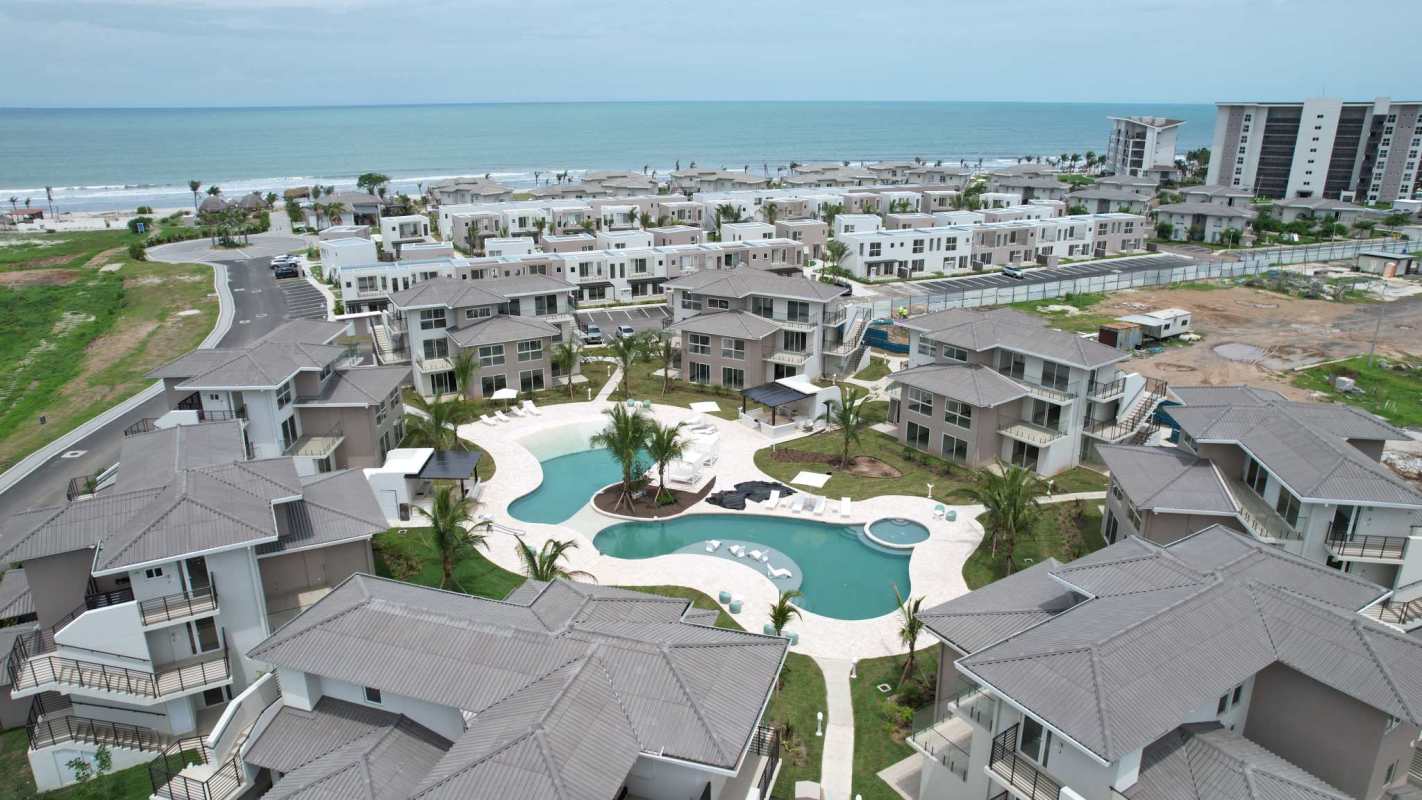 Aerial of beach condos, large pools, palm trees and ocean views Punta Chame