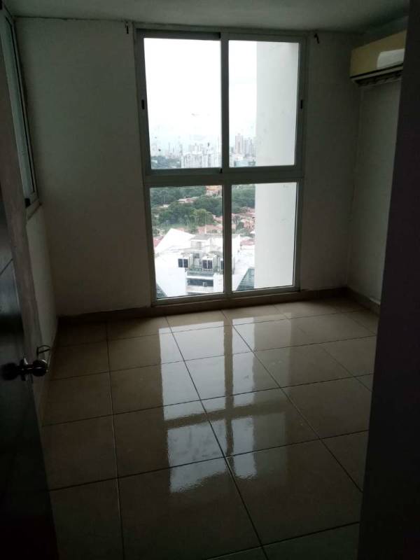 Empty living room with ceramic floors and balcony access in PH Kings Park Condado del Rey Panama City
