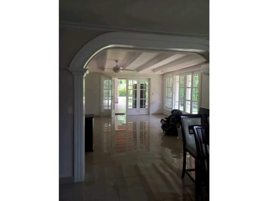 Bright living room with large windows, tiled floor and ceiling beams in Ancon Panama City