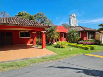 Large bedroom with green walls, window seat, ceiling fan, in luxury Coronado golf villa near beach Panama