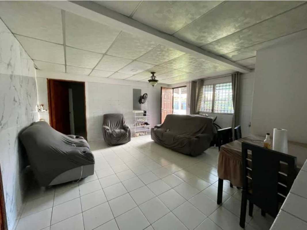 Simple living dining room tiled floor large windows with bars Panama multifamily