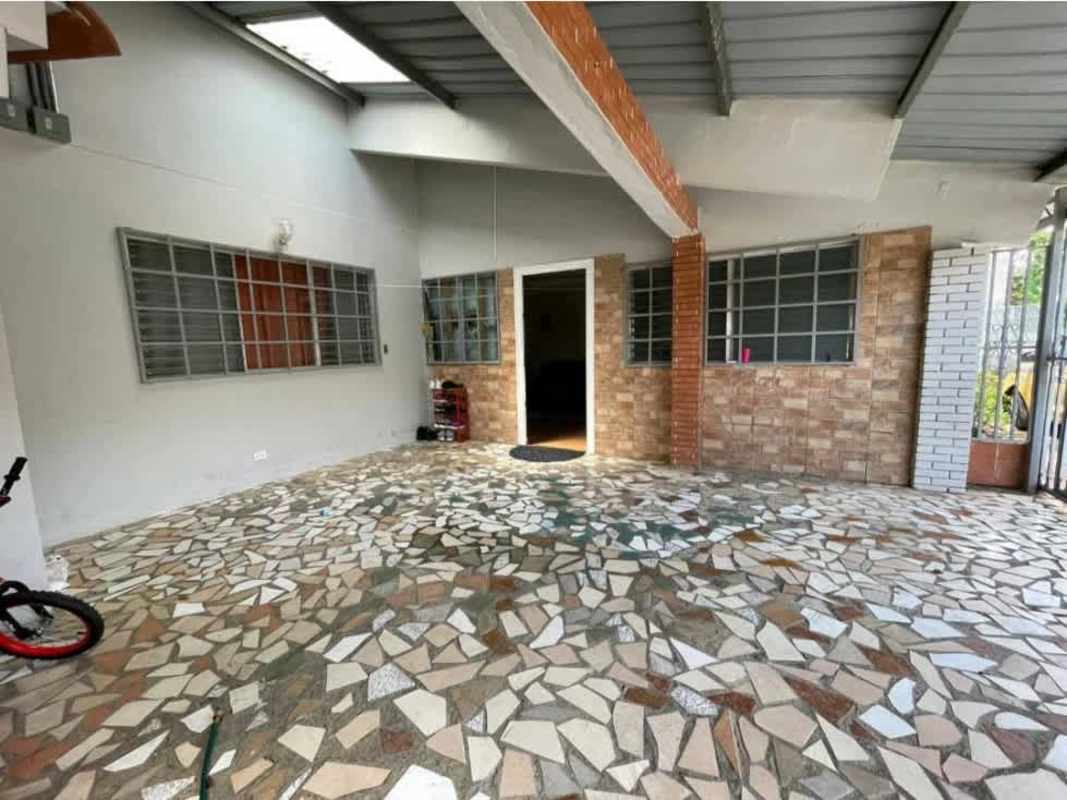 Covered outdoor patio area with brick wall iron grills stone floor investment property Rufina Alfaro