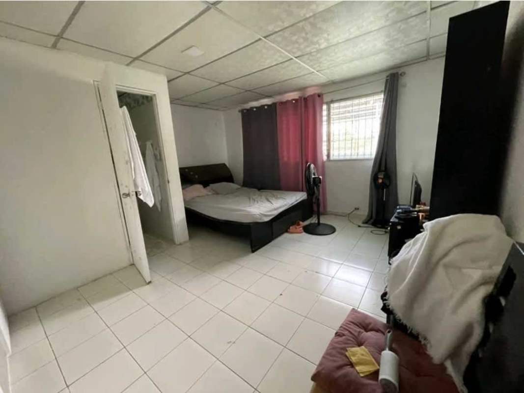 Simple bedroom with tiled floor window with bars curtains investment house San Miguelito