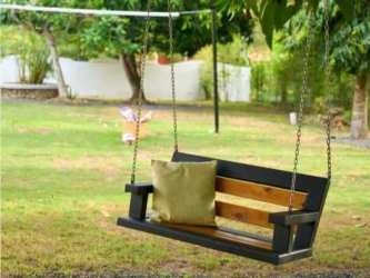 Spacious covered outdoor terrace with sofas facing garden and pool at Coronado Golf El Palmar Panama