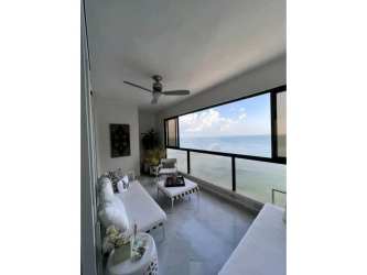 Modern dining room with marble floors, large windows, and contemporary furniture in Punta Paitilla luxury apartment
