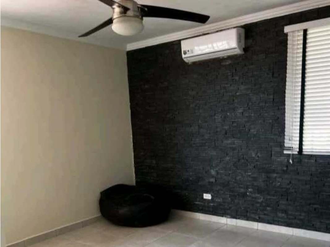 Living room with black accent wall ceiling fan AC and tile flooring Castel Novo Panama