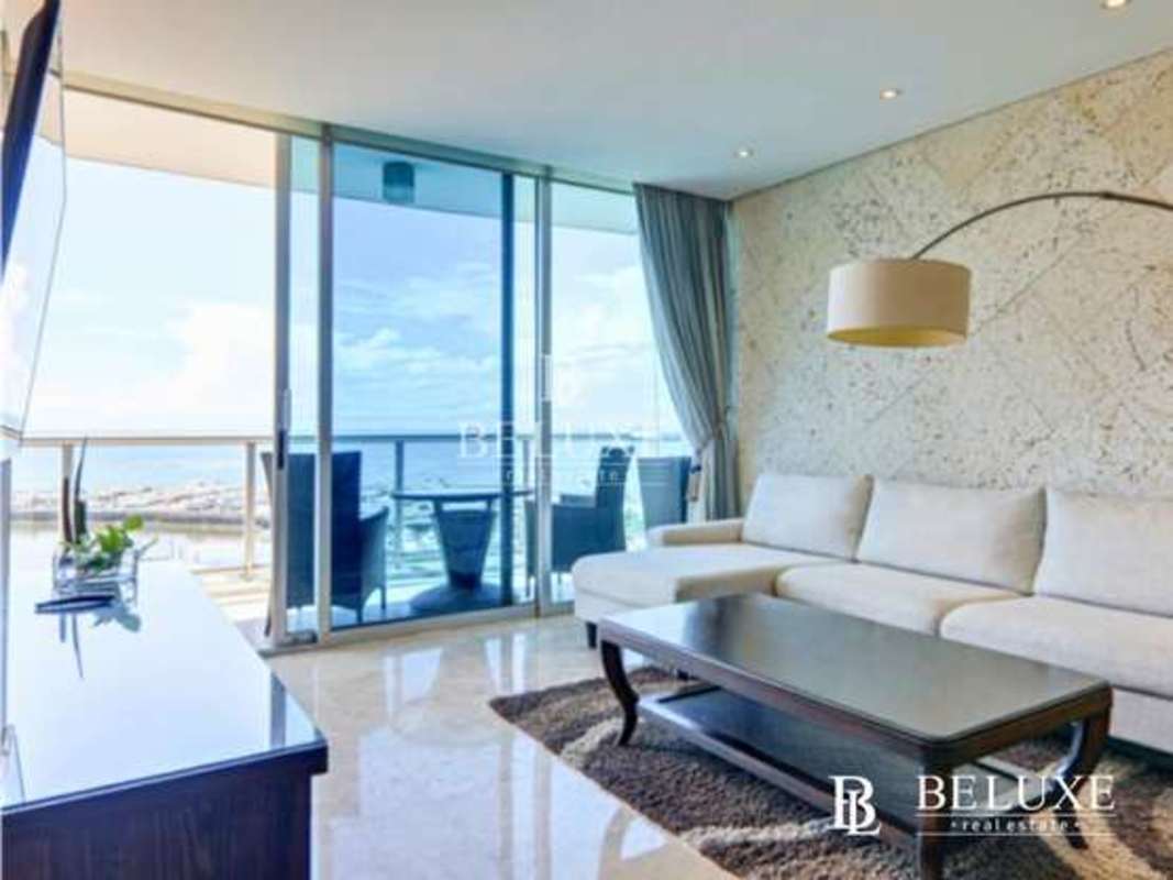 Bedroom with king size bed, ensuite bath, view of ocean balcony at PH Sky Residences Panama