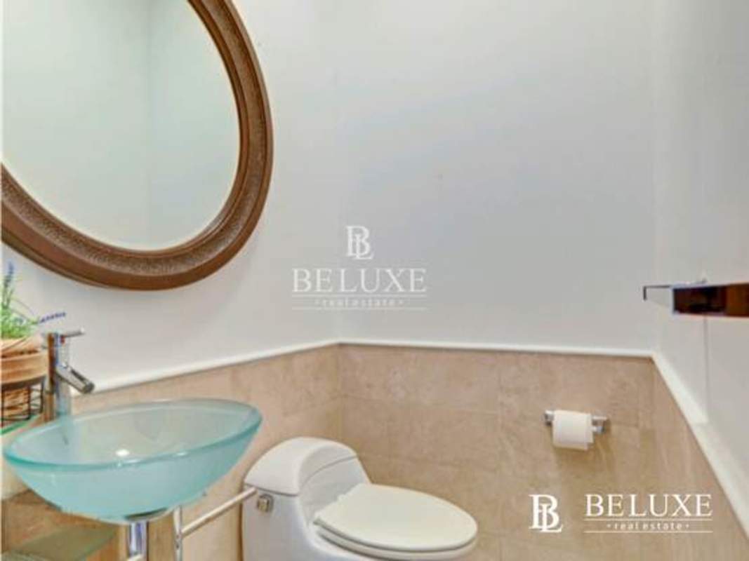 Kitchen with granite countertop, wood cabinets, stainless appliances in PH Sky Residences Panama