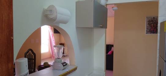 Living room with colorful accent wall, tile floors, natural light Sorá Chame countryside Panama