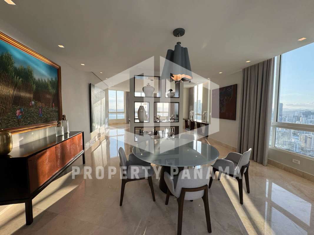 Contemporary dining area with marble floors, floor-to-ceiling windows overlooking city skyline and Pacific Ocean Punta Pacífica