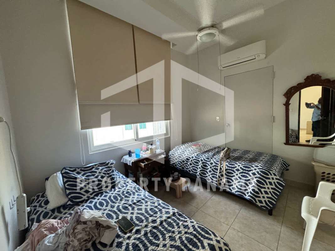 Modern living room with floor-to-ceiling windows and panoramic ocean and skyline views Punta Pacífica Panama